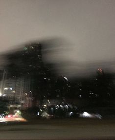 blurry photograph of city skyline at night