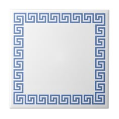 a white tile with blue greek border