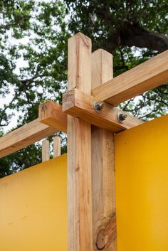 a close up of a wooden structure with metal studs on the top and bottom