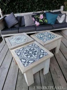 three tables sitting on top of a wooden deck next to a couch and coffee table