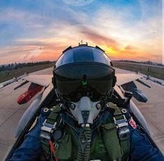 the view from inside an airplane looking down at the cockpit and pilot's helmet