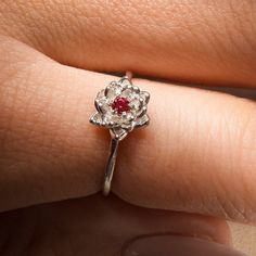 July Ruby Birth Flower Ring Material: Choose from Solid 14k Yellow Gold, 14k White Gold, 14k Rose Gold, or 925 Sterling Silver. Stone: 2 mm genuine AA grade brilliant cut Band: Solid 1.3 round band Water Lily Flower: Ruby Ring Water lily – Symbolize pleasure and peace Ruby Birthstone: The ruby has become a symbol of love and commitment. It was once thought to protect against misfortune and illness. ✿ This piece comes in a lovely Amelia Ray Jewelry gift box. My pieces are ideal gifts for birthday Lab-created Ruby Birthstone Diamond Promise Ring, Lab-created Ruby Birthstone Diamond Ring For Promise, Lab-created Ruby Diamond Promise Ring With Birthstone, Lab-created Ruby Birthstone Ring In Fine Jewelry Style, Promise Lab-created Ruby Birthstone Ring, Ruby Birthstone Ring In White Gold For Promise, Diamond Flower Ring With Birthstone For Anniversary, Solitaire Ruby Ring For Promise, White Gold Ruby Birthstone Promise Ring