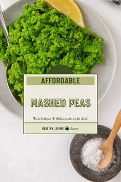 a bowl filled with mashed peas next to a spoon on top of a table