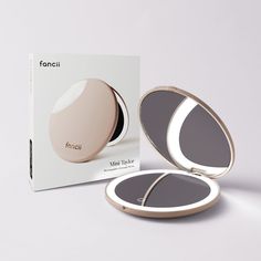 the compact mirror is next to its box