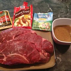 raw meat, spices and seasoning on a plate next to a cup of coffee