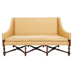 a beige couch with wooden legs on a white background