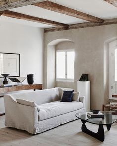 a living room filled with furniture and a glass table