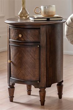 a wooden table with two drawers and a coffee cup on top