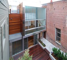 an apartment building with wooden floors and glass windows on the second floor is shown from above