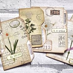 several pieces of old fashioned paper with flowers on them and tags attached to the side