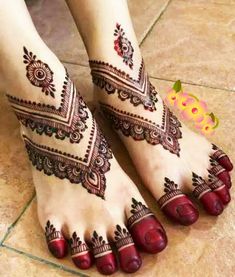 the feet are decorated with henna designs