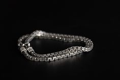 Elevate your night out with the Venetian Box Chain Bracelet, crafted to complement an edgy and sophisticated style. Whether you're stepping out for a night on the town or adding a touch of refinement to your everyday look, this versatile piece is a must-have. Wear it solo for a subtle statement or layer it with the Mooring Chain Bracelet for an added edge. Made in Italy and assembled in NYC, it embodies the fusion of timeless craftsmanship and contemporary flair, making it ideal for those who ai Timeless Formal Bracelet With Box Chain, Modern Snake Chain Bracelet For Formal Events, Modern Snake Chain Bracelet For Formal Occasions, Luxury Link Bracelets With Box Chain, Modern Double Chain Bracelet As Gift, Timeless Box Chain Bracelet As Gift, Luxury Bracelets With Box Chain And Link Shape, Luxury Sterling Silver Bracelet Gift, Silver Box Chain Jewelry For Evening