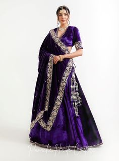 The violet color of lehenga set adds a regal touch, while the shawl can provide an additional layer of warmth and elegance. It is adorned with intricate embroidery, sequins, or other embellishments to make it stand out. When wearing a lehenga set, it's important to choose accessories that complement the outfit without overpowering it. A simple pair of earrings, a bracelet, and a clutch in a complementary color can be all that is needed to complete the look. Overall, a Violet Color Lehenga Set with a shawl from the Sensual Shadows Collection can be a stunning choice for anyone looking to make a statement with their fashion choices. The vibrant colors and intricate details are sure to turn heads and make the wearer feel like royalty. Brand: Panache Haute Couture Collection Name: The Sensual Traditional Embroidered Pre-draped Saree For Formal Occasions, Purple Sharara With Cutdana And Traditional Drape, Purple Anarkali Pre-draped Saree For Reception, Purple Pre-draped Saree With Cutdana For Reception, Purple Pre-draped Saree For Wedding, Traditional Purple Sharara With Drape, Traditional Purple Sharara With Traditional Drape, Elegant Purple Choli With Traditional Drape, Reception Purple Pre-draped Saree With Pallu