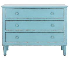 a blue dresser with three drawers and two knobs on the bottom, against a white background