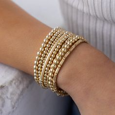 Textured Bracelet Stack – Hayden B. Jewelry Gold Bracelets With Round Beads For Layering, Elegant Stacked Bracelets With Round Beads, Gold Stretch Bracelet For Layering, Gold Stackable Stretch Bracelet For Layering, Elegant Gold Stacked Bracelets, Elegant Stacked Gold Bracelets, Gold Stackable Beaded Bracelets For Layering, Gold Stacked Bracelets With Round Beads, Gold Bracelets With Tiny Beads For Layering