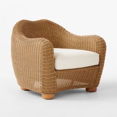 a wicker chair with a white cushion