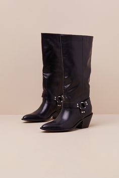 Create signature looks all season long with the help of the Lulus Assia Black Slip-On Knee-High Moto Boots! Super smooth faux leather shapes these slip-on boots with a pointed-toe upper that rises to a 13"" knee-high shaft with a 14.75"" circumference. Three matching studded straps come together at the outstep and instep via a shiny silver O-ring for a moto-inspired effect. A stacked block heel completes the look! 2. 5" stacked block heel. Cushioned insole. Rubbed sole has nonskid markings. Man Edgy Knee-high Heeled Boots For Spring, Edgy Spring Knee-high Heeled Boots, Edgy Wide Calf Mid-calf Boots For Fall, Edgy Pointed Toe Knee-high Boots For Winter, Western Knee-high Faux Leather Boots, Edgy Knee-high Moto Boots For Fall, Fall Knee-high Moto Boots Medium Width, Fall Wide Calf Knee-high Boots With Snip Toe, Edgy Knee-high Boots For Workwear In Fall