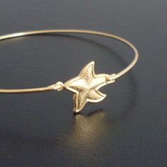 Starfish Bangle Bracelet Gold Starfish Bracelet by FrostedWillow, $15.50 Adjustable Star Charm Bracelet, Star-shaped Bracelet With Starfish Charm Gift, Starfish Charm Bracelet As Gift, Adjustable Gold Star Charm Bracelet, Adjustable Gold Star Bracelet, Gold Charm Bracelet With Starfish For Beach, Adjustable Star-shaped Jewelry With Starfish Charm, Starfish Charm Bracelet As A Gift, Starfish Charm Bracelet Gift