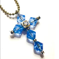 a blue glass cross is hanging from a chain