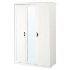 a white wardrobe with mirrored doors and drawers