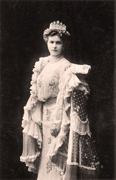 an old black and white photo of a woman wearing a tiara