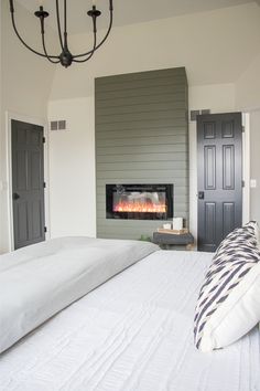 a bedroom with a fireplace in the wall