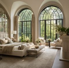 a large living room with high arched windows