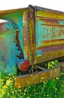 an old rusty dumpster sitting in the middle of a field