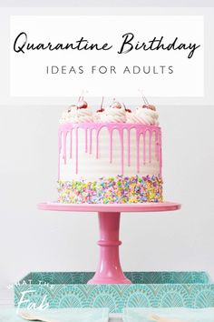 a birthday cake with pink icing and sprinkles on top is sitting on a table