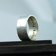 a silver ring with the word love written on it