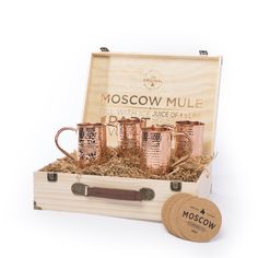 the moscow mule copper mugs are in a wooden box