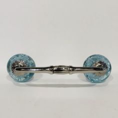 a metal handle with blue glass beads on it