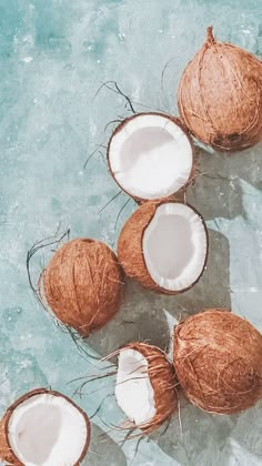 three coconuts are sitting on the ice and one is cut in half