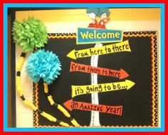 a bulletin board decorated with colorful paper flowers and signs that say, welcome from here to there