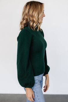 Dark emerald green color Soft knit material has stretch Turtleneck Sleeves widen near bottom Ribbed at neck, sleeve cuffs, and hem 57% Viscose, 27% Polyester, 17% Polyamide Casey is 5'8, cup size 32B, size 2 and wearing size S Trina is 5'6, cup size 32D, size 2 and is wearing size S Sierra is 5’8, cup size 37”, size 6/8 and wearing size M Dark Emerald Green, Emerald Green Color, Weather Seasons, Classic Sweater, Cup Size, Knitting Materials, Soft Knits, Turtleneck Sweater, Emerald Green