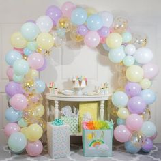 an arch made out of balloons and confetti for a birthday party or baby shower