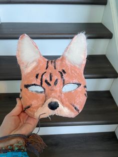 Hi and welcome to my shop! This beautiful serval cat mask is purrfect for anyone wanting a nice and cozy mask! This mask comes without fake eyes, but you can add them on or wear it without! The mask features tall ears, like on a serval, with lots of faux fur inside. The mask shows off the beauty of the serval with its stripes. Please check all photos, as this is ooak and not perfect. Since the mask is fully lined, it's very comfortable! Thanks for supporting my small business! Message me with an Halloween Cat Design Masks With Cat Ears, Cat Ears Masks With Whiskers For Masquerade, Masquerade Cat Ears Mask With Whiskers, Halloween Cat Ears Mask With Whiskers, Halloween Cat Design Masks And Prosthetics With Cat Ears, Masquerade Masks With Cat Design And Cat Ears, Serval Cat, Serval Cats, Fake Eye