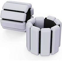 two white and black bracelets sitting next to each other