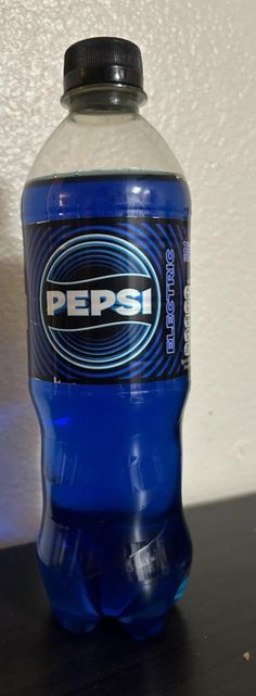 a bottle of pepsi soda sitting on top of a table