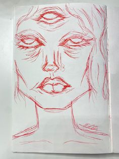 a drawing of a woman's face is shown in red ink on white paper