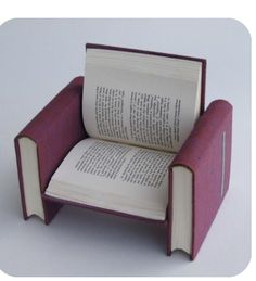 an open book sitting on top of a chair