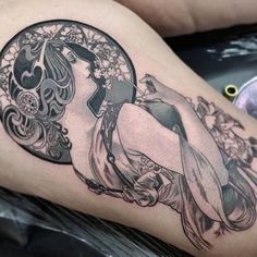 a woman's thigh with a tattoo design on it