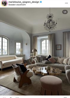 a living room filled with furniture and a chandelier