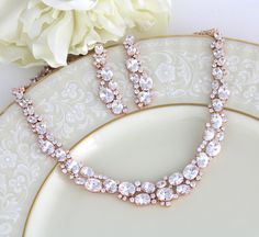 "This gorgeous Rose gold bridal jewelry set features dozens of oval and round CZ gemstones. This sparkling accessory is perfect for your wedding day! Size: Necklace: Length: 16'' and extends to 18\", Earrings: Length: 2'' You can choose a backdrop for this piece as well, please choose from the drop down menu. Matching bracelet: https://www.etsy.com/listing/265281912/rose-gold-bracelet-crystal-bridal Statement backdrop: https://www.etsy.com/listing/272743856/rose-gold-backdrop-necklace-bridal-bac Rose Gold Bridal Jewelry Set, Rose Gold Necklace Set, Gold Bridal Jewelry, Rose Gold Bridal Jewelry, Bridal Backdrop Necklace, Rose Gold Wedding Jewelry, Gold Backdrop, Jewelry Rose Gold, Backdrops Necklace