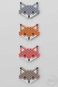 three different colors of beaded fox head pins