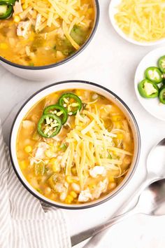 two bowls of chicken chili soup with cheese and jalapenos on the side