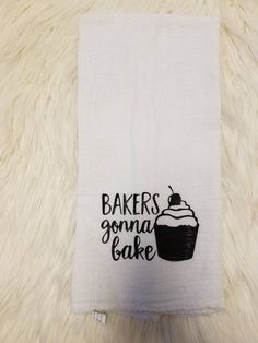 a kitchen towel with the words bakers goma cake on it and a cupcake