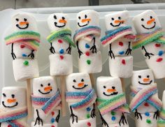 marshmallow snowmen are decorated with multicolored candy