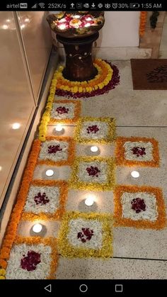 the floor is decorated with flowers and candles for diwaling or decorating it