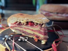 a sandwich cut in half sitting on top of a black plate next to other food items